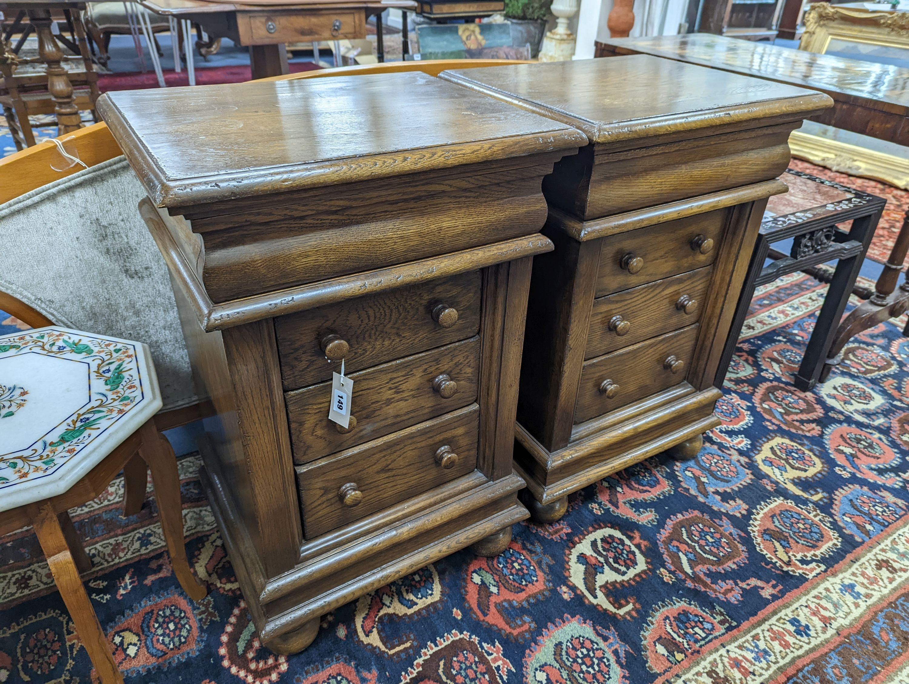 A pair of reproduction oak four drawer bedside chests, width 51cm, depth 41cm, height 79cm